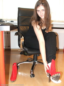 Taking Off Crimson Boots And Ankle Socks At A Desk